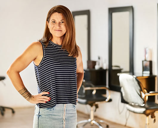 Business owner standing confidently in her salon