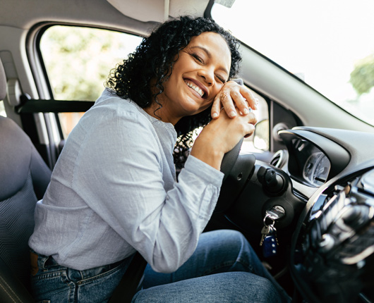 Young woman driving car.