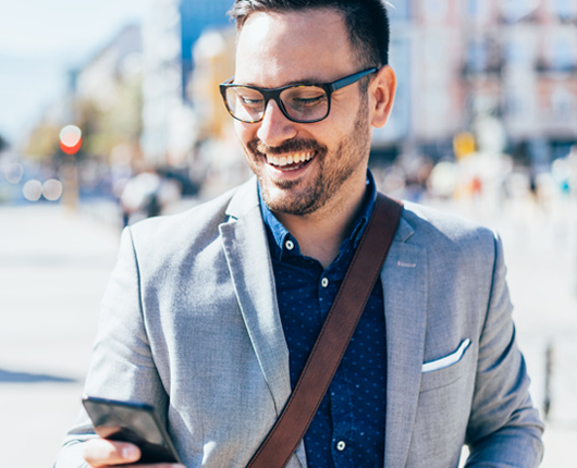 Man smiling with smart phone.